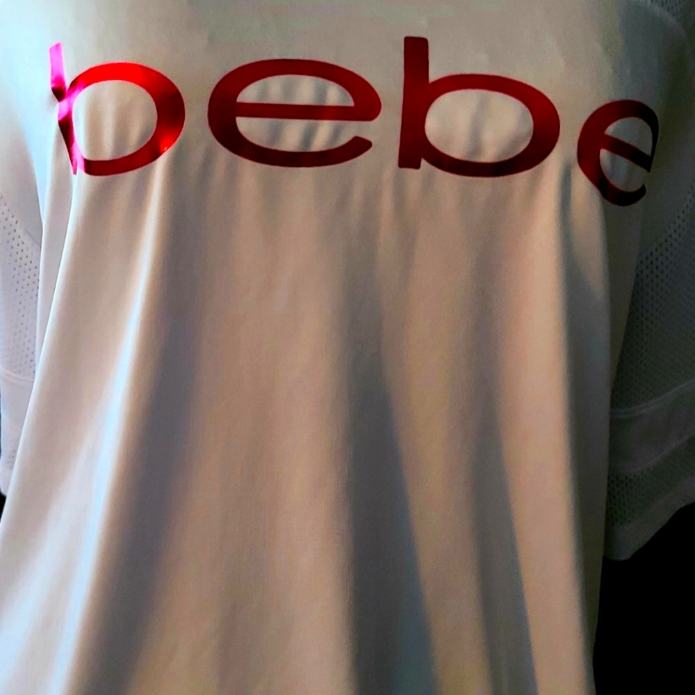Bebe womens shirt size XL color White with Pink. Mesh back.